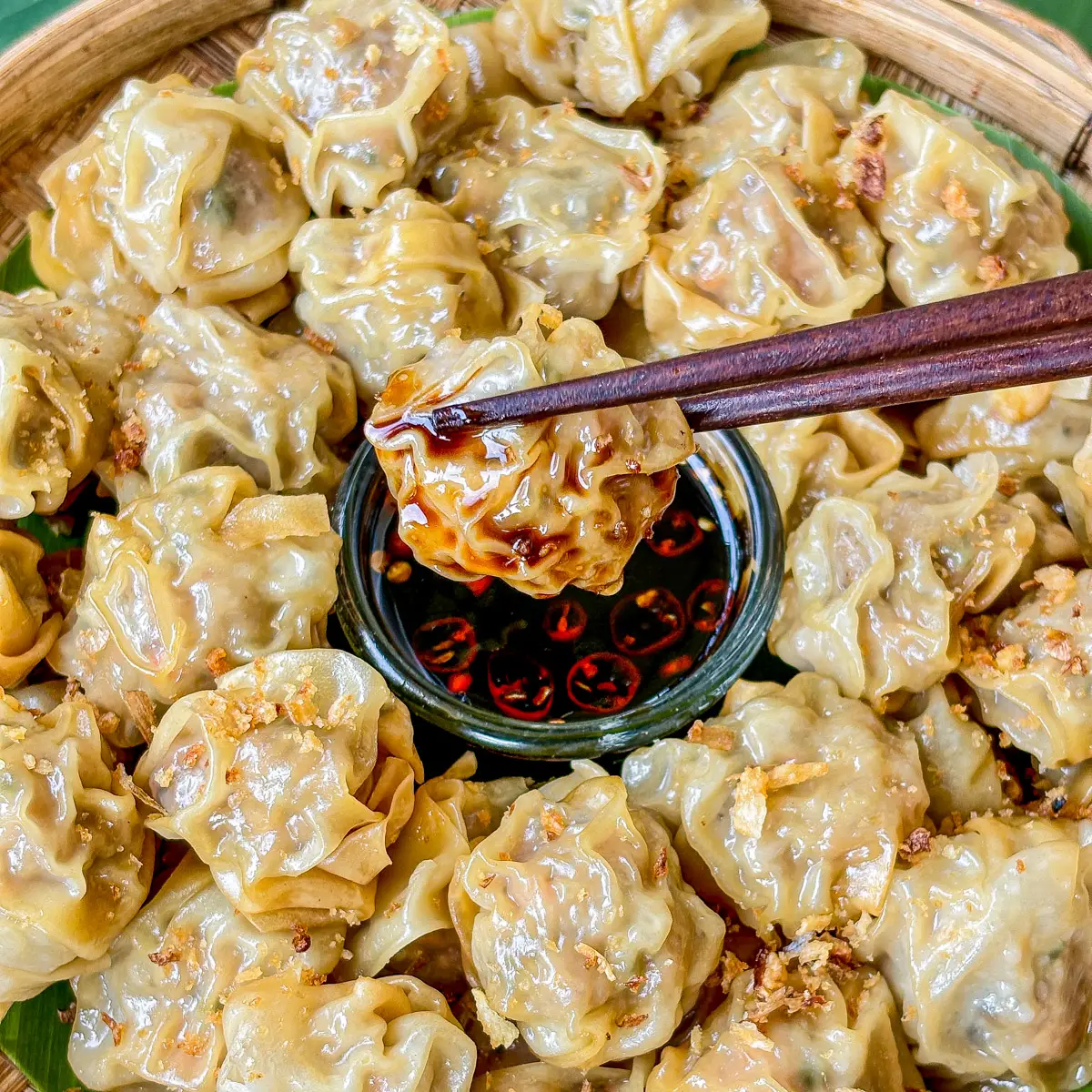 A steamer basket of Chinese-style steamed dumplings, the same family as Thai khanom jeeb